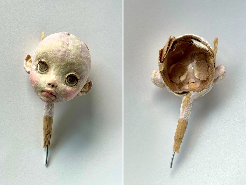 和紙人形の顔の正面と、和紙を重ねた後頭部の内側